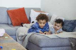 Black children lying on couch