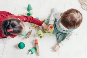 Children playing with animal toys