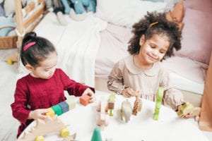 Girls playing on a white table