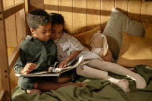 Two kids reading a fairy tale book