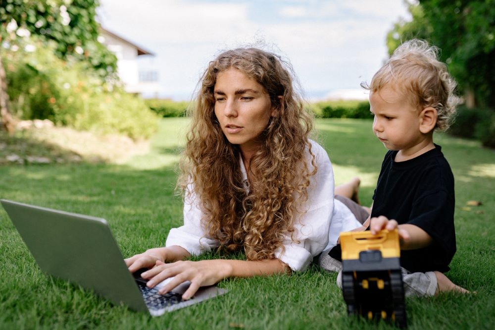 Woman working while parenting.