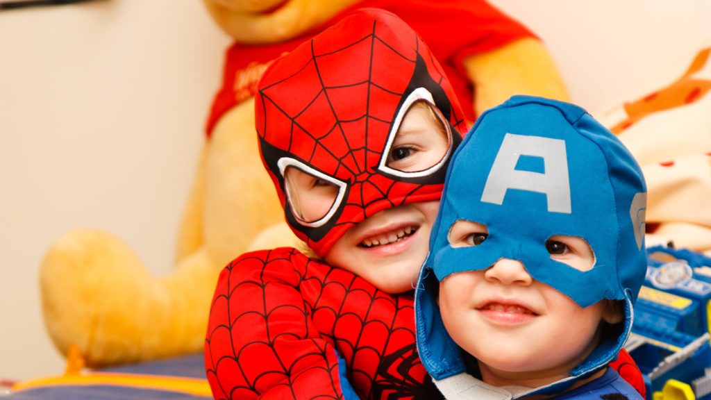 Two little boys dressed as Spiderman and Aquaman.